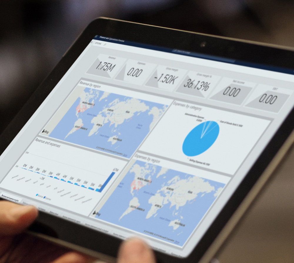 A person holding a tablet displaying analytics charts, including maps and graphs, reflecting global data metrics.