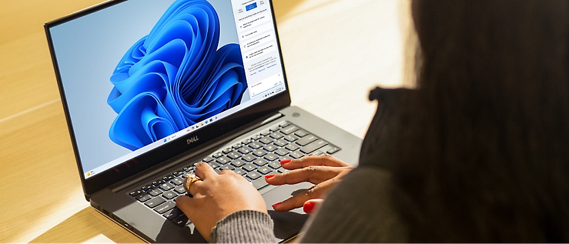 A woman sitting at a desk with Laptop.