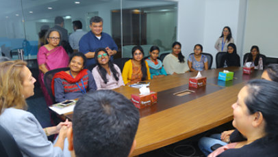 A group of mostly women in a business meeting.