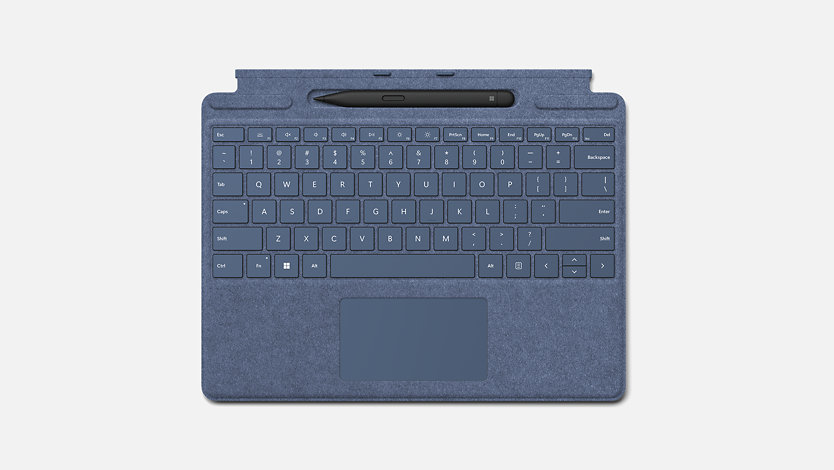 A sapphire blue Surface Pro Signature Keyboard with a Slim Pen 2 resting in the built-in pen tray.