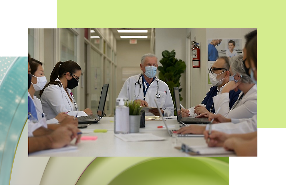 A group of doctors, wearing masks, talking with each other