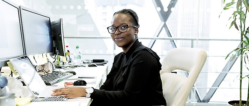 A person sitting at a desk and smiling.