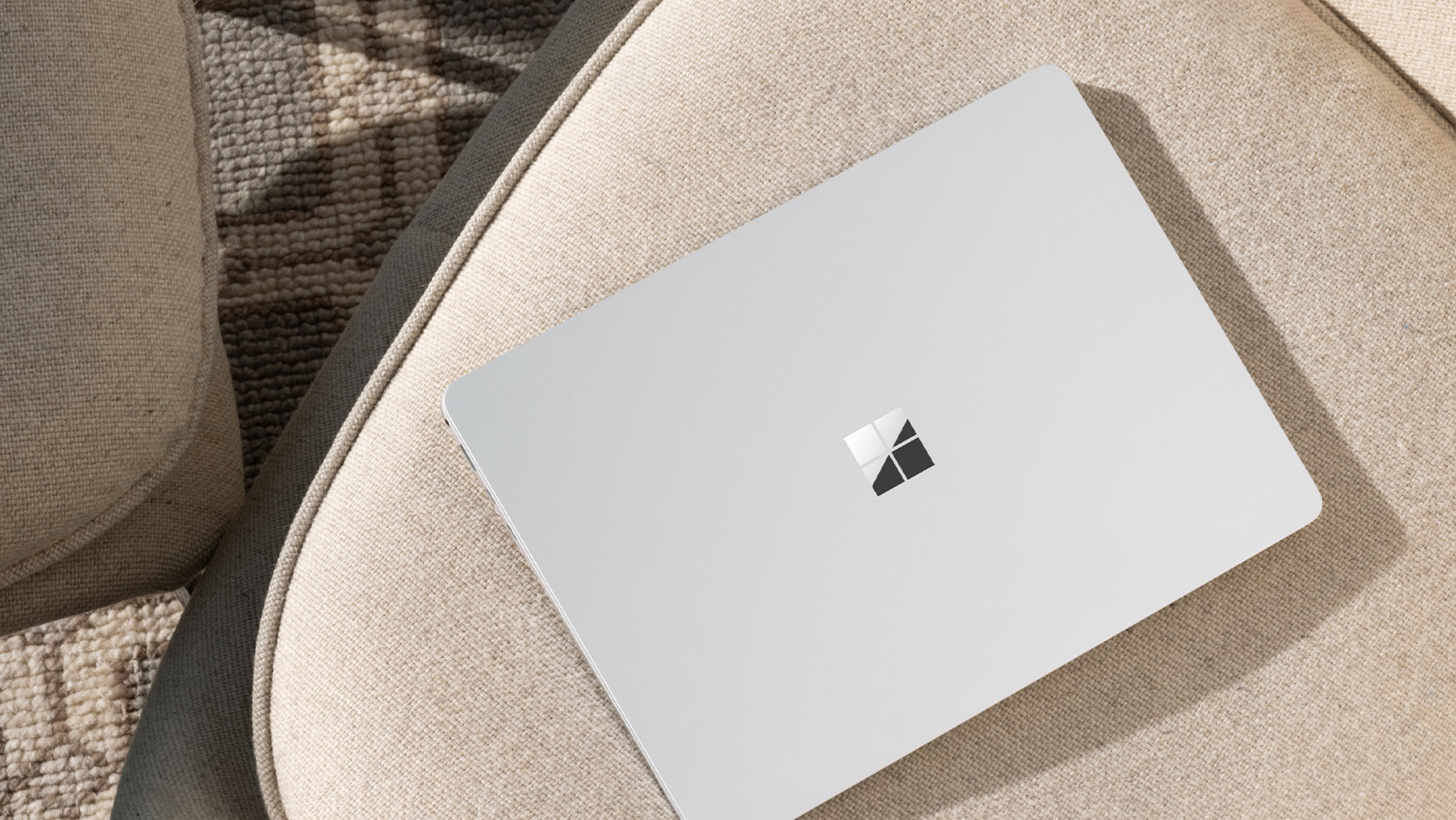 A top-down view of a Surface Laptop for Business device left unattended in a public place, suggesting the security of the device.