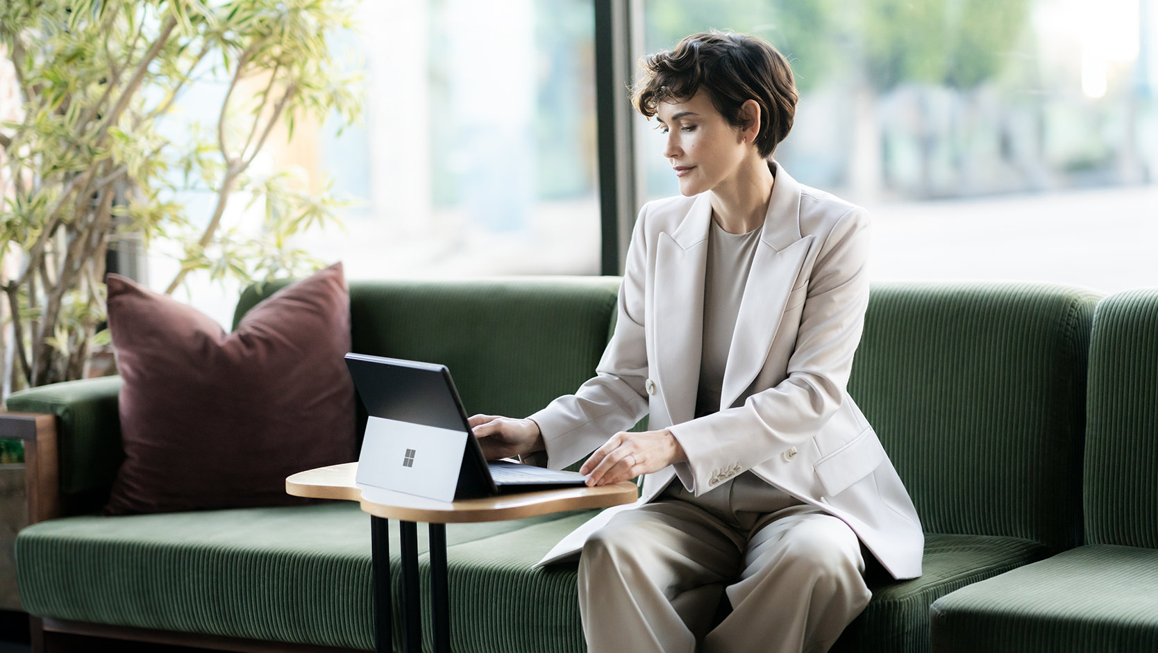 A person uses a Surface Pro Keyboard for Business to type on a Surface device.