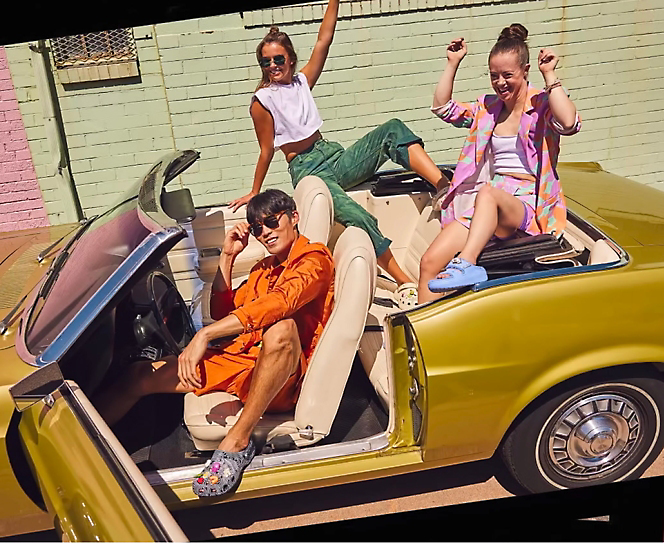 Group of people sitting in open roof car and enjoying