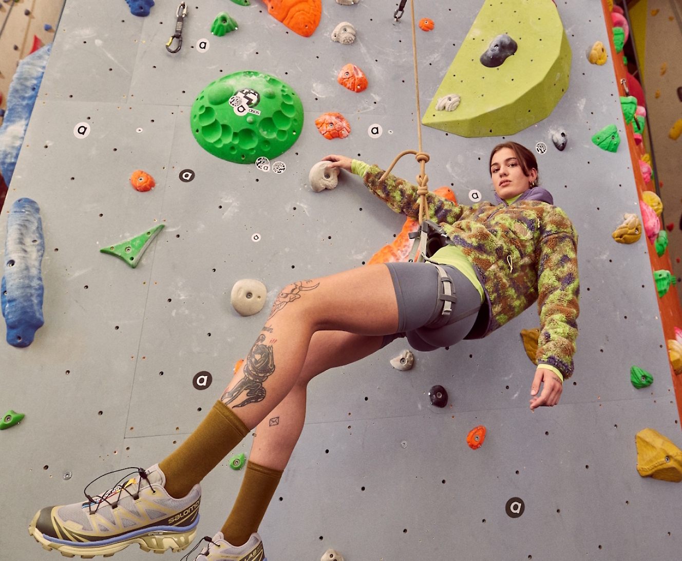 A girl climbing a rock wall