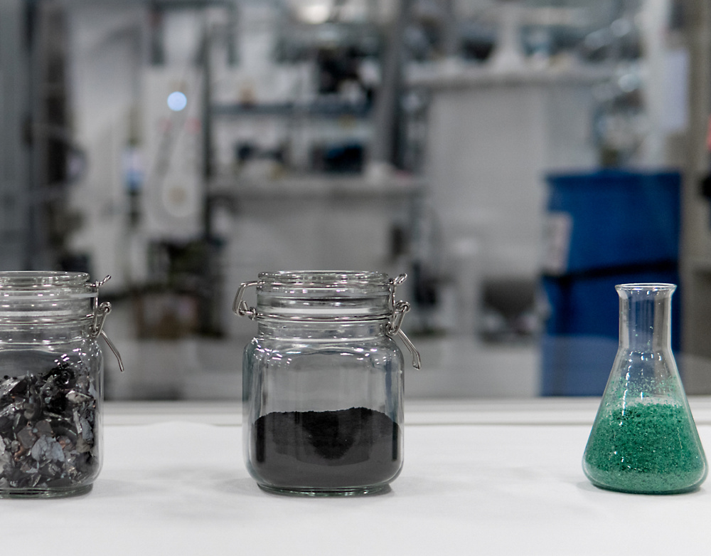 A group of glass jars with colored powder