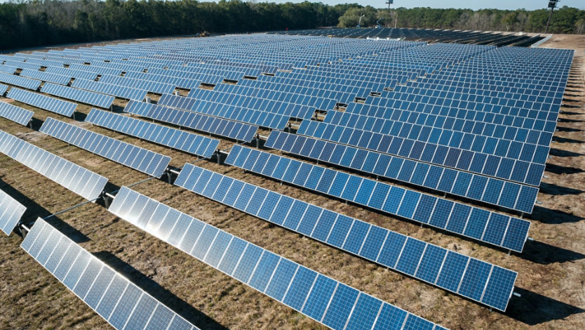 Field with rows of solar panels.