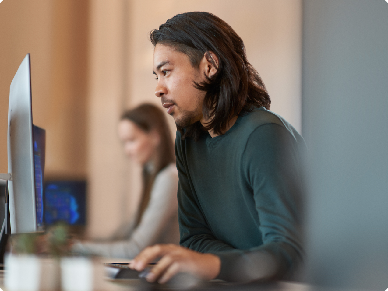 A person sitting at a desk using a computer