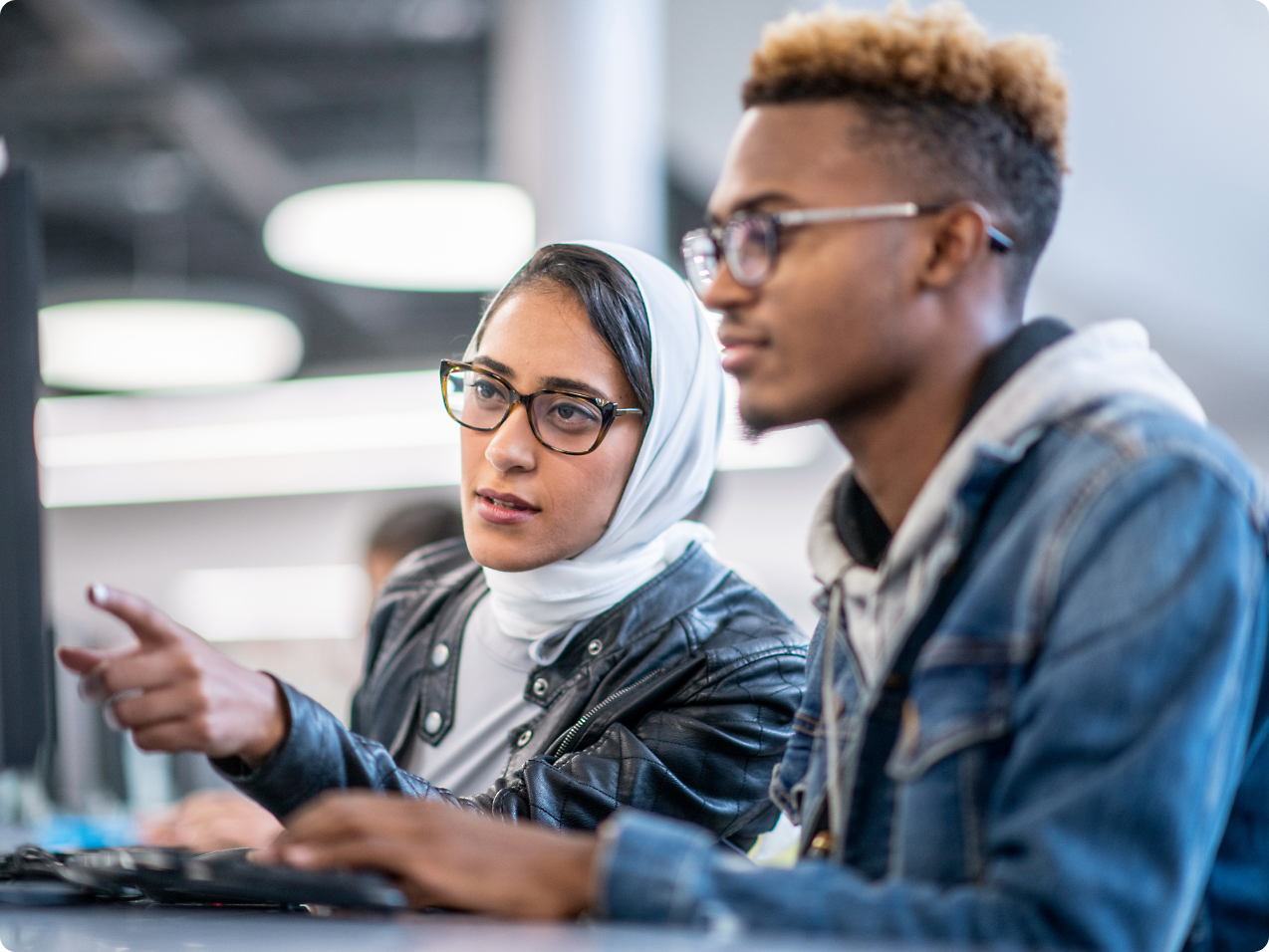 A person and person looking at a computer