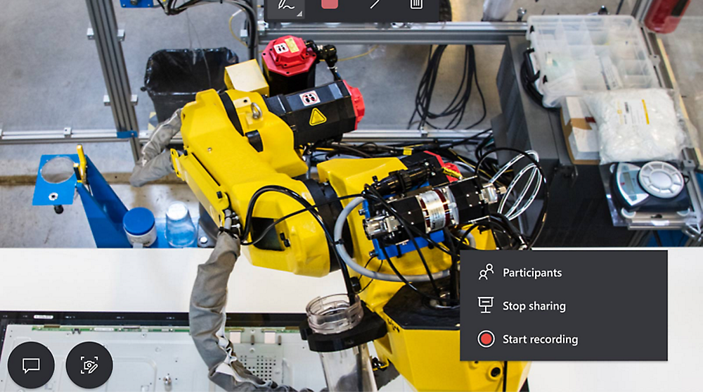 Robotkar a munkaterületen, a képernyőn látható videokonferencia-vezérlőkkel