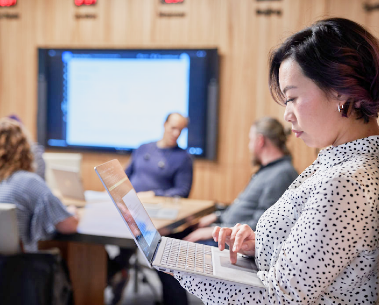 A person is using a computer in a meeting room