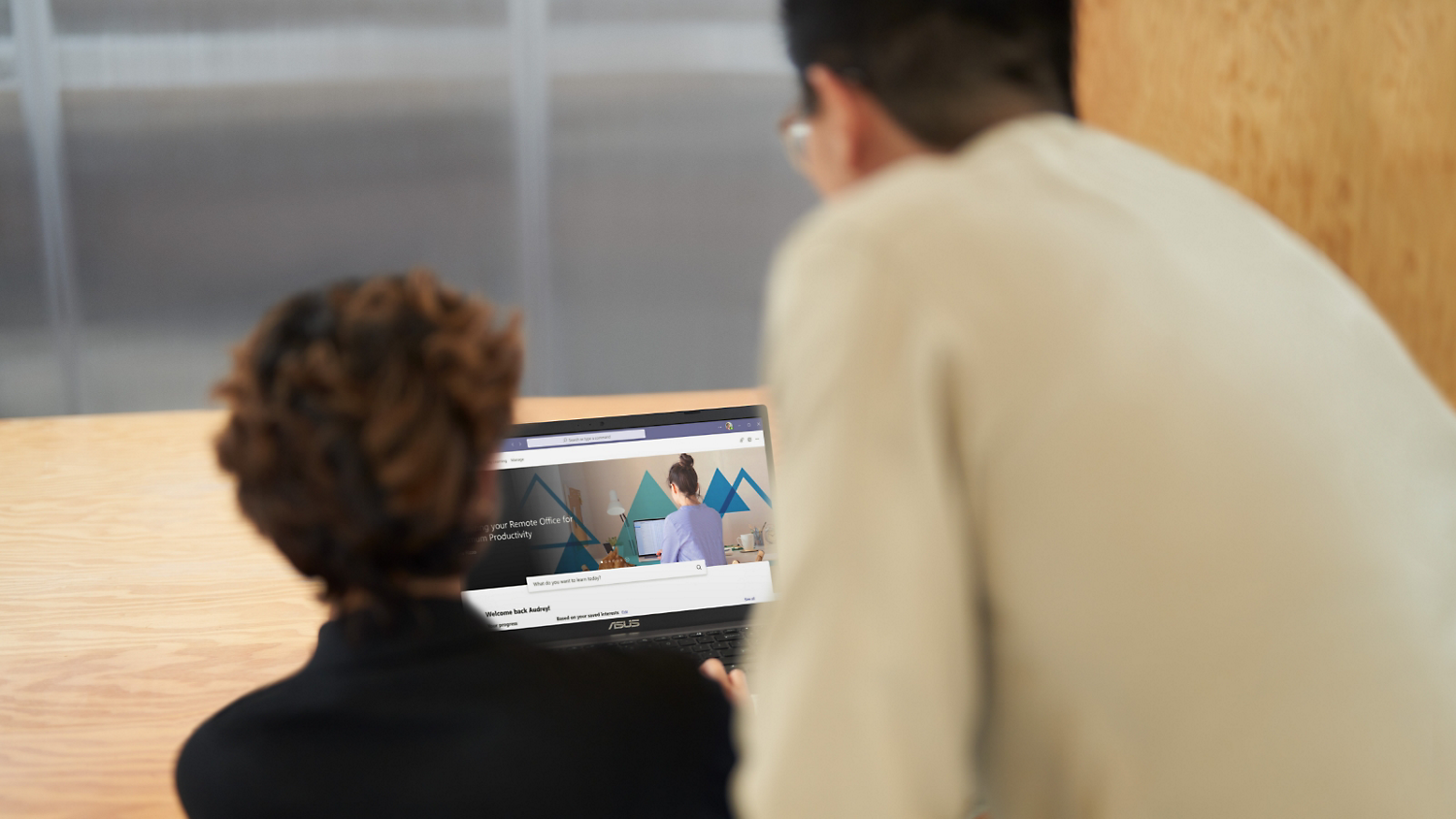 Two people looking at a laptop