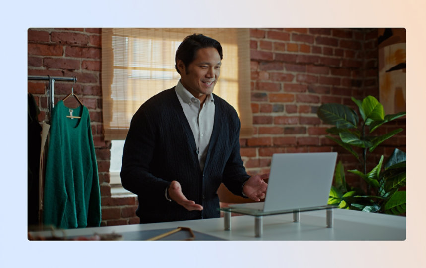 Man in business suit holding laptop outside