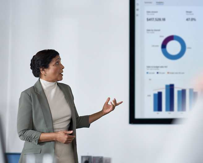 A person giving a presentation in a big screen