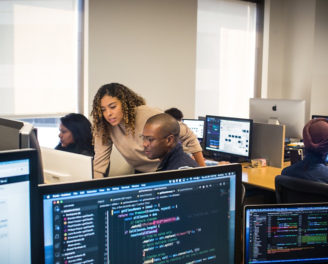 Group of people sitting in the office and working with their system