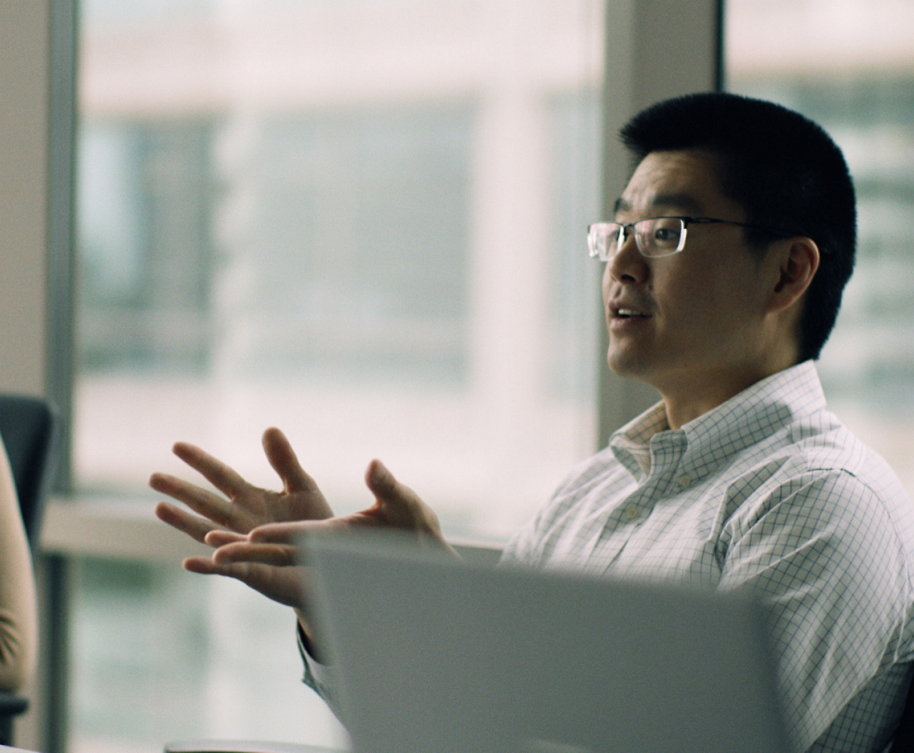 A person in glasses talking to a person