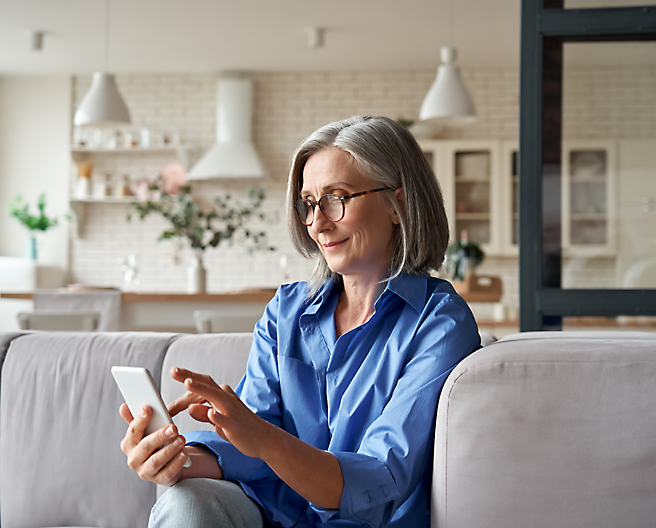 A person sitting on a couch using a phone