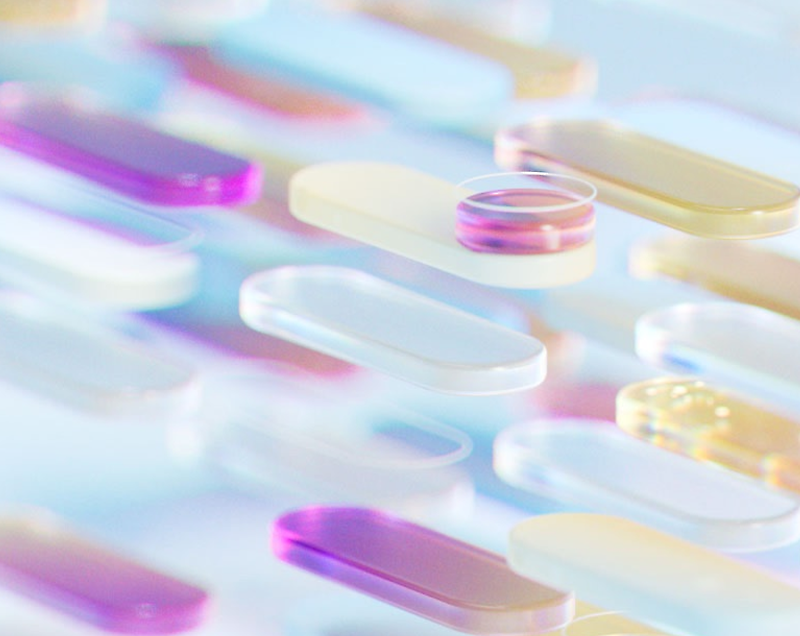 Various colorful pills floating in a surreal, dreamlike space.