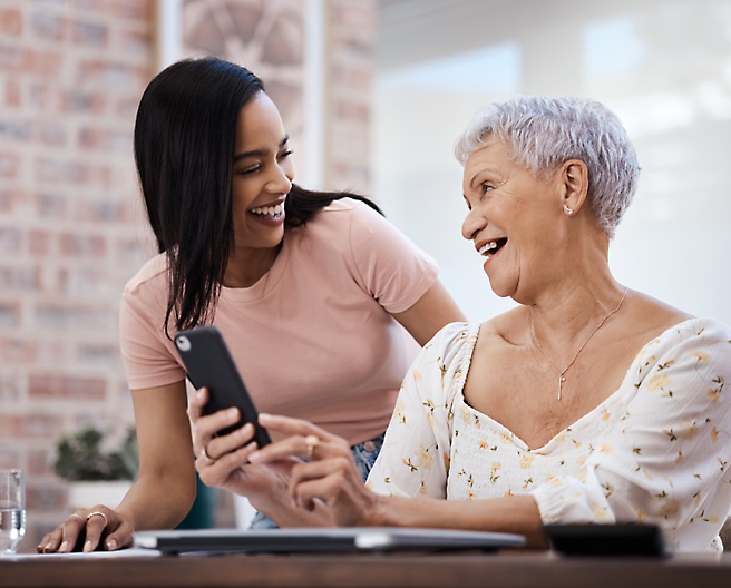 A person showing a phone to an old person