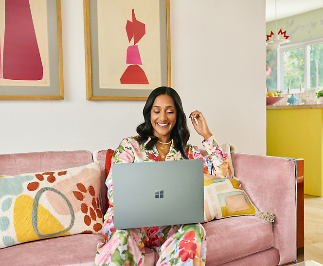 A person sitting on a couch using a laptop