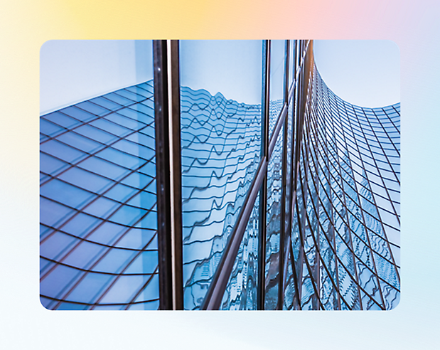 Reflection of a wavy skyscraper facade on an adjacent glass building.