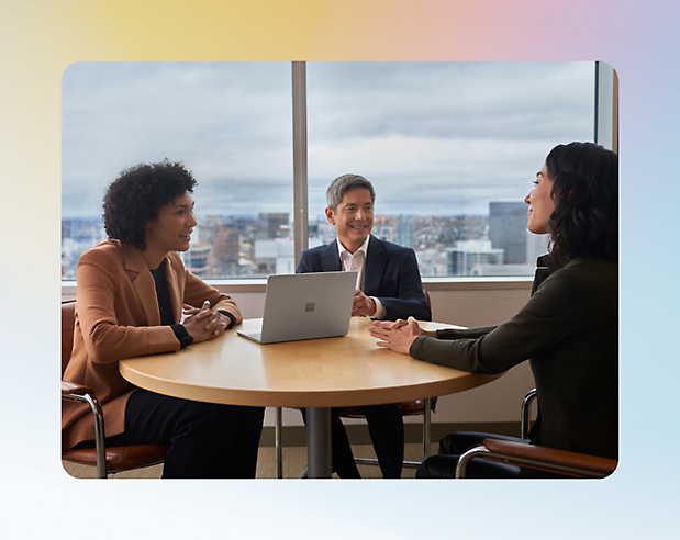 Three prople discussing something in a office