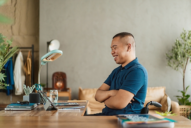 A man at a desk looking at his computer