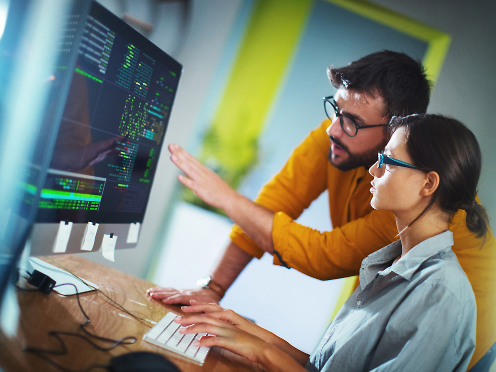 Two person's looking at a computer screen