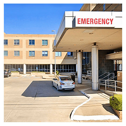 A car in front of an emergency room