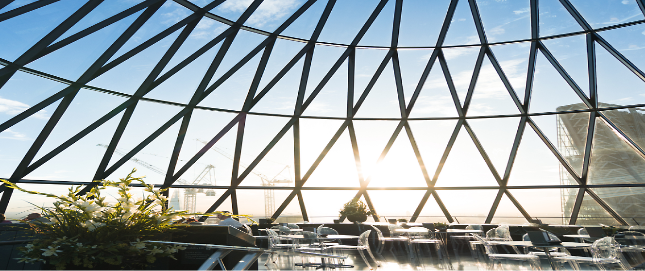 A glass dome with a sun shining through