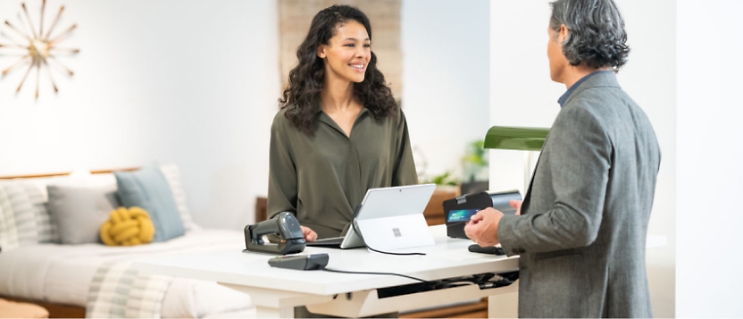 A man and woman standing at a desk.