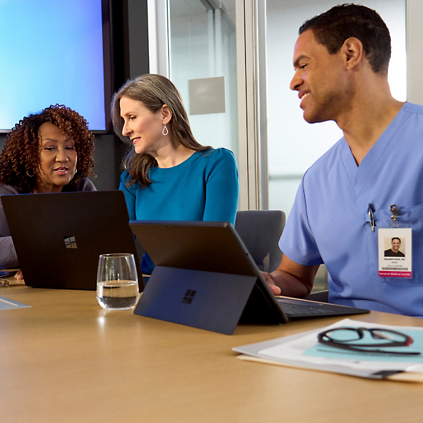 A group of people looking at laptops