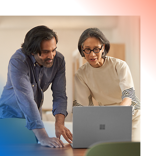 Two persons discussing while working on the laptop