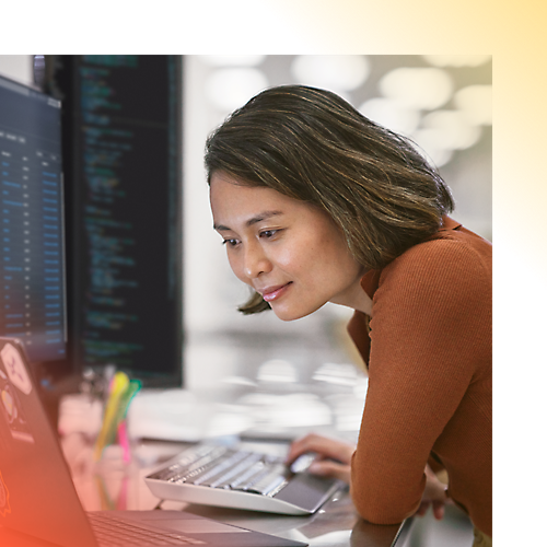 A woman working on desktop.