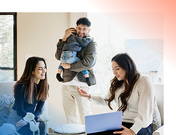 Family enjoying time together at home with a young child on an adult's shoulders 