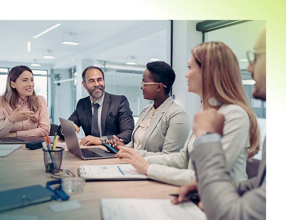 Four professionals in a modern office setting talking with each other.