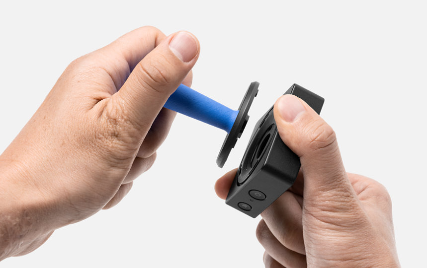 A pair of hands assembles Microsoft Adaptive Joystick Button.