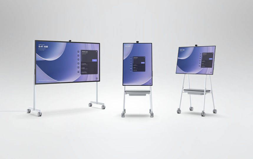 A Surface Hub 3 85" and two Surface Hub 3 50" devices on Mobile Stands. 