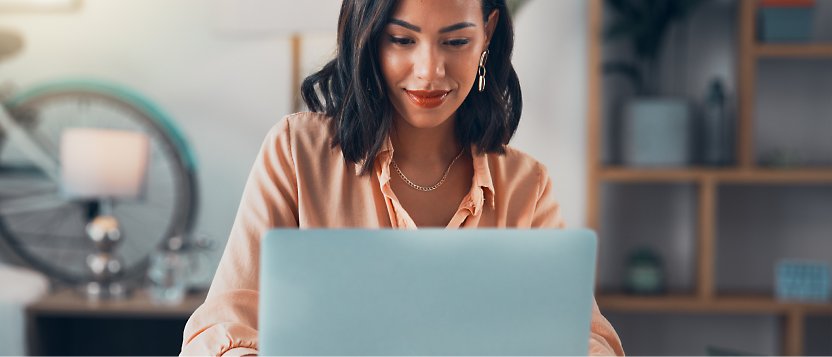 A person using multiple monitors and working in her office