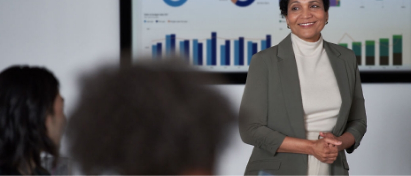 A woman is giving a presentation to a group of people.