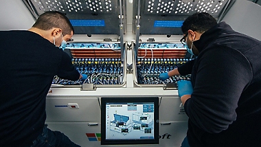 Two employees working on a datacenter server.