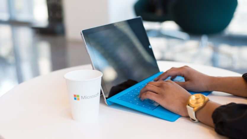  A man using a 2-in-1 laptop