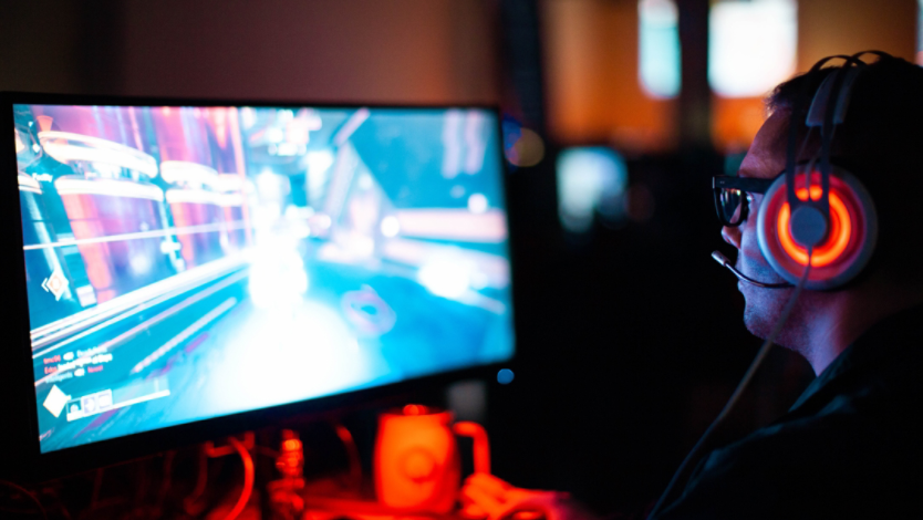 A man playing a video game on his desktop computer