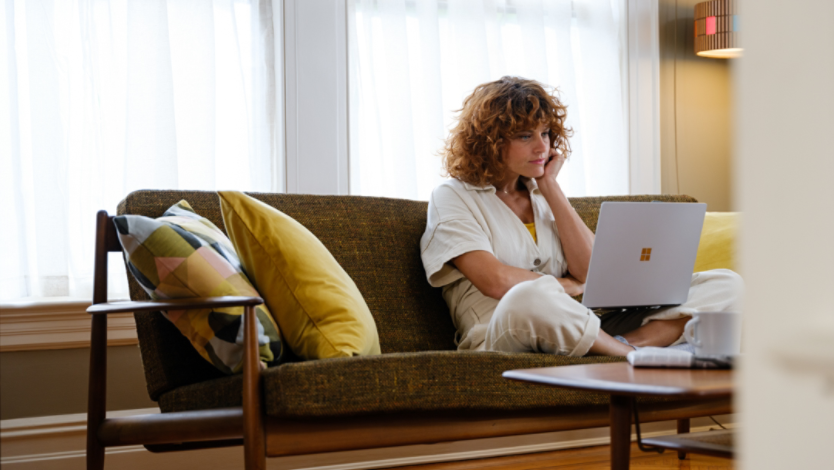 A person sitting on a chair using a laptop