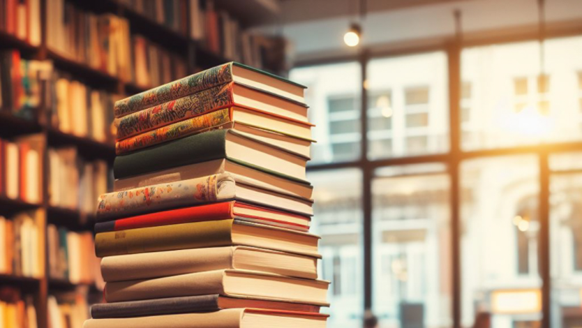 A stack of books on a table at a bookstore