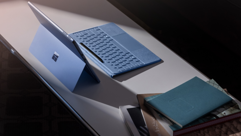 A sapphire Surface Pro 11ᵗʰ Edition and detached Surface Pro Flex Keyboard with a Surface Slim Pen in its digital pen holder