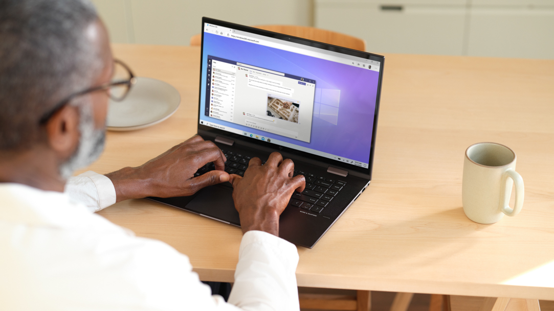 Man sitting at a table using laptop