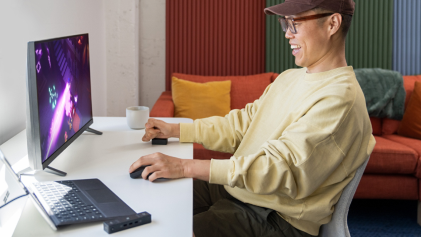 Man playing games on his computer using Microsoft adaptive accessories