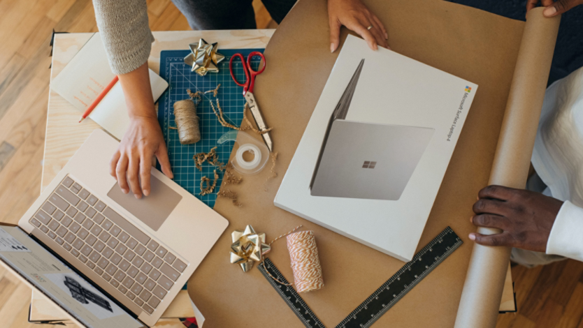 Overhead view of a person wrapping a Surface device